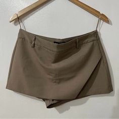 Zara Asymmetrical Tan/Taup Hight Waisted Skort 2 Pockets Brand New With Tag Waist 35” Beige Asymmetrical Bottoms For Work, Asymmetrical Beige Bottoms For Work, Fitted Asymmetrical Beige Bottoms, Asymmetrical Skort For Summer Workwear, Asymmetrical Summer Workwear Skort, Elegant Asymmetrical Hem Skort For Summer, Zara Bottoms With Asymmetrical Hem For Summer, Zara Asymmetrical Hem Bottoms For Summer, Beige Asymmetrical Bottoms For Summer