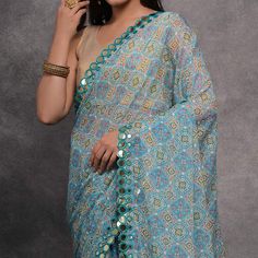 Blue colored saree is made from georgette fabric which is highlighted with beautiful bandhani printed mirror work as shown. Comes along with unstitched heavy satin gota blouse piece which you can customise as per your design/style. Occasion - You can wear this saree for casual and daily wear. Note:- the actual product may differ slightly in color and design from the one illustrated in the images when compared with computer or mobile screen. Measurements: Saree : Georgette : 5.5 Mtrs Blouse : Geo Bandhani Print Georgette Traditional Wear For Navratri, Navratri Georgette Traditional Wear With Bandhani Print, Georgette Bandhani Print Choli For Festivals, Festival Bandhani Print Georgette Sharara, Festival Georgette Choli With Bandhani Print, Festival Georgette Traditional Wear With Bandhani Print, Bollywood Style Blue Sharara With Motifs, Festival Traditional Wear With Bandhani Print In Georgette, Festive Bandhani Print Georgette Dupatta