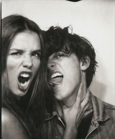 two people are posing for the camera with their mouths open