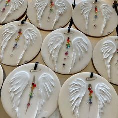 white ceramic angel wings with beaded beads on them