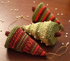 two knitted cones sitting on top of a wooden table