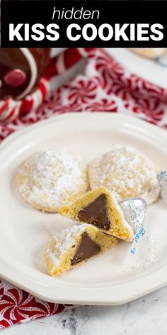 a white plate topped with cookies covered in powdered sugar