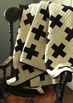 a black and white quilt sitting on top of a chair