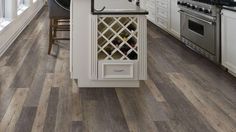 a kitchen with wood floors and white cabinets