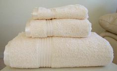 three white towels stacked on top of each other