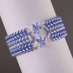 the bracelets are decorated with blue and white beads