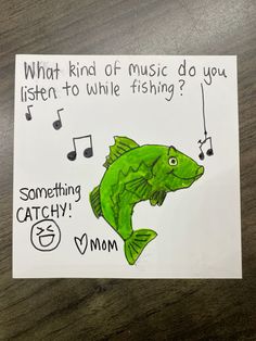 a piece of paper with an image of a fish on it and music notes in the background