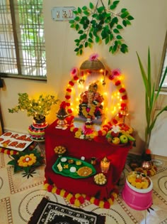 there is a small shrine set up with food on the table and decorations around it