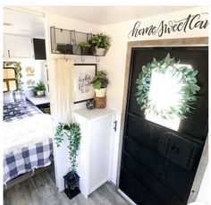 a bedroom with a black door and white bed