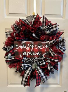 a red and black wreath that says, comfy cozy are we