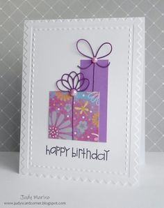 a happy birthday card with purple and white gift boxes on the front, decorated with flowers