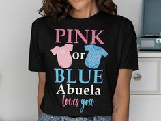 Celebrate the big reveal with our Gender Reveal Pink or Blue Abuela loves you T. Shirt! This adorable tee is perfect for the proud Abuela to be at their Gender Reveal Party. It's a fun and cute way to announce the gender of your little one to friends and family. Made of soft and comfortable material, this shirt is perfect for wearing to your baby shower or any other special occasion leading up to the arrival of your bundle of joy. Make the big announcement in style with our Abuela Gender Reveal Party Baby Announcement T. Shirt. Order yours today and get ready to share the exciting news with everyone you love! Pink Tops With Funny Text For Gender Reveal, Black Crew Neck Top For Gender Reveal, Crew Neck T-shirt For Gender Reveal With Text Print, Blue T-shirt With Text Print For Gender Reveal, Pink Crew Neck T-shirt For Gender Reveal, Pink Letter Print T-shirt For Gender Reveal, Blue T-shirt With Text Print For Mother's Day, Blue Family Matching T-shirt For Gender Reveal, Blue T-shirt For Gender Reveal With Text Print