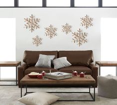 a living room with couches, tables and snowflakes on the wall