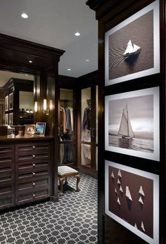 a large walk in closet with pictures on the wall