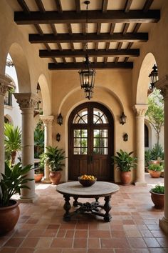 an entry way with potted plants and a table on the ground in front of it