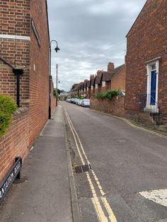 an empty street lined with brick buildings