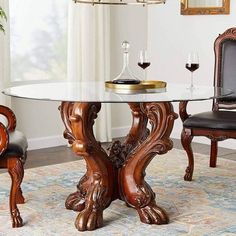 a dining room table with chairs and a wine glass on the top one is in front of a chandelier