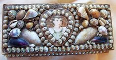 a decorative box with shells and a woman's face on it