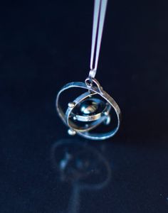 This kinetic solar system is hand made in sterling silver  Spinning Solar System…