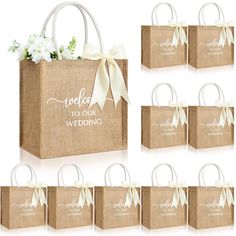 six bags with white flowers in them and the words welcome to our wedding on them