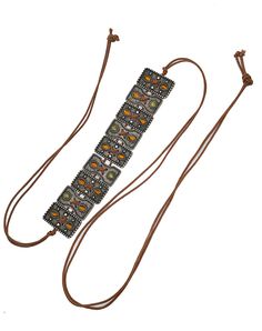 This tie belt is made with unique, embellished slider ornaments with Olive and Topaz colored stones on a brown cotton rope. 52" Full length One size adjustable Acrylic stones Imported Summer Fashion Brown Jewelry, Brown Adjustable Jewelry For Festivals, Brown Adjustable Festival Jewelry, Brown Sliding Knot Jewelry For Beach, Hippie Style Brown Jewelry For Summer, Brown Hippie Jewelry For Summer, Brown Beach Jewelry With Sliding Knot, Hippie Style Brown Summer Jewelry, Brown Adjustable Length Jewelry For The Beach