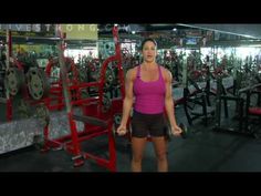 a woman standing in front of a gym machine