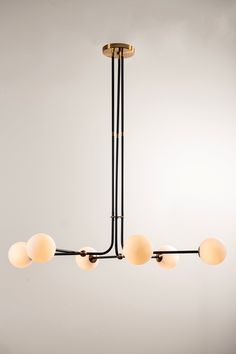 a modern chandelier with five lights hanging from it's center and four arms