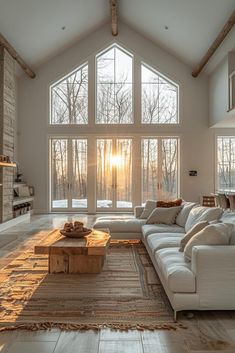 a living room with large windows and white furniture