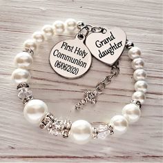 This pretty white pearl bracelet would make a stunning gift and keepsake for your Granddaughter on her First Holy Communion. The bracelet is made using 10, 8 & 6mm white pearls along with Swarovski Ab bicone beads that shimmer in the light and a sparkling rhinestone crystal bead. The charms are stainless steel , please leave the engraving details you require ie.. Date of Communion in the box on the listing. Please choose the size you require from the drop down box to order. Your bracelet wil Gift For Granddaughter, White Pearl Jewelry, Goddaughter Gifts, White Pearl Bracelet, First Communion Gifts, Bracelet Box, Communion Gifts, First Holy Communion, Daughter Of God