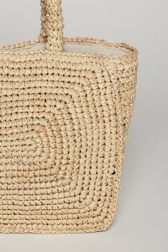 Crafted from 100% raffia straw with a 100% linen lining. Perfect for the summer season, this tote combines durability with understated elegance. Whether you're heading to the beach or exploring the city, it's the ideal accessory for carrying your essentials. Woven Neutral Straw Bag, Neutral Woven Straw Bag, Rectangular Neutral Straw Bag For The Beach, Neutral Woven Jute Straw Bag, Summer Beach Bag With Rolled Handles In Jute, Neutral Straw Tote Bag For Beach, Woven Neutral Beach Bag For Summer, Neutral Tote Straw Bag For Beach, Neutral Woven Beach Bag For Summer