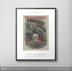 a framed poster hanging on the wall above a white wall with a black frame and an image of a skeleton