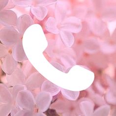 the phone is surrounded by pink flowers