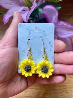 💫Come visit my shop!💫    --Cosmic CrysDals--        https://cosmiccrysdals.etsy.com Whimsical Sunflower 🌻 Earrings  Sunflower resin charm with yellow glass accent bead on gold rings -925 silver plated gold wires Yellow Sunflower Dangle Earrings, Yellow Sunflower Design Dangle Earrings, Yellow Sunflower Design Earrings For Gift, Yellow Sunflower Design Earrings As Gift, Yellow Sunflower Design Earrings Gift, Yellow Hypoallergenic Flower-shaped Earrings, Yellow Sunflower Design Flower Earrings As Gift, Yellow Sunflower Dangle Jewelry, Yellow Sunflower Design Dangle Jewelry