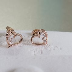 "Sweetly and symbolic are these heart-shaped stud earrings. Available in 14K yellow rose or white gold, each open heart-shaped earring is half-lined with shimmering diamonds, while the other half is smoothly polished. ♥ Absolutely the perfect gift for any occasion and stacks well with other Earring styles. Detail: Height: 9.4mm Width:9.5mm Thickness: 1.3mm Stone Material: Available in Mined Diamond or Cubic Zirconia Stone Shape: Round Total Number of Stones: 10 Stone Setting: Prong Metal: Solid Fine Jewelry Heart Earrings For Pierced Ears, Elegant Heart-shaped Earrings As Gift For Her, Elegant Rose Gold Heart Cut Earrings, Fine Jewelry Heart Pendant Earrings As Gift, Fine Jewelry Heart Pendant Earrings For Gift, Fine Jewelry Double Heart Earrings For Valentine's Day, Elegant Pierced Heart Earrings Gift For Her, Valentine's Day Fine Jewelry Double Heart Earrings, Fine Jewelry Heart Pendant Earrings For Valentine's Day