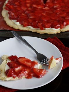 a piece of strawberry pie on a plate with a fork