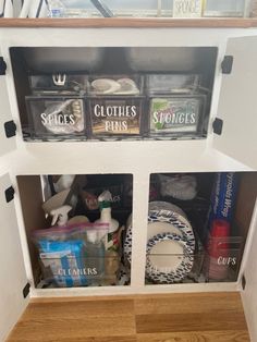 the inside of a kitchen cupboard filled with clutter and other household items in containers