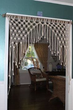 a room with green walls and white curtains