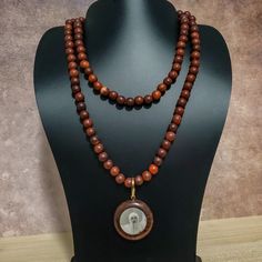 37" This Uniquely Designed Double Sided Photo Pendant Necklace Expertly Combines Wild Country Rosewood and Meditation Beads for an Elegant and Timeless Look. Handcrafted with Quality Materials, The ORIGINAL OSHO Rajneeshpuram Wild Country Rosewood Meditation Beads Mala Necklace Is the Perfect Accessory for Your Mindful Journey. ✥ Pendant size ✥ Necklace length - 37" (w/o pendant 35") ✥ Handmade by Artisans in India ❀❀❀Please look closely at photos as part of item description, the product in the Wooden Beads Amulet Jewelry For Meditation, Traditional Wooden Beads Necklace For Meditation, Meditation Amulet With Wooden Beads, Traditional Wooden Bead Necklaces For Meditation, Holistic Wooden Beads Necklace As A Gift, Holistic Style Necklace With Wooden Beads, Holistic Style Necklace With Wooden Beads For Gifts, Holistic Wooden Beads Necklace For Gift, Holistic Style Wooden Beads Necklace For Gifts