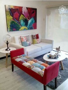 a living room filled with furniture and a painting on the wall