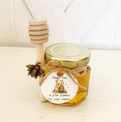 a jar of honey with a wooden spoon next to it