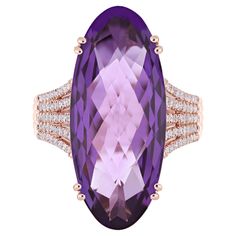 Elegant and exquisitely detailed 14 Karat Rose Gold Ring, Elongated Checkerboard Faceted Cabochon Oval Shape Amethyst weighing approx. 12.35Cts and micro pave set Diamond with approx. 0.38Cts Beautifully Hand crafted in 14 Karat Rose Gold Ring Stone Detail: Primary Stone: Amethyst Primary Stone Size: 28X12MM Primary Stone Cut: Cab Checker Primary Stone Shape: Oval Primary Stone Weight: 12.35Cts Approx Diamond GH/SI Total Diamond Weight: 0.38Cts Approx Once of our most Popular is this Stunning Am Elongated Oval, Amethyst And Diamond Ring, Stone Cuts, Micro Pave, Amethyst Ring, Cocktail Rings, Rose Gold Ring, Or Rose, Gold Ring