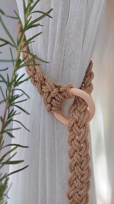 a close up of a curtain with a wooden ring on it's center piece