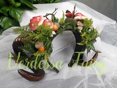 an arrangement of plants and mushrooms is displayed on a white tablecloth with the words claudia fairy above it