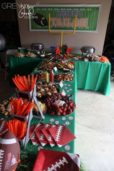 a football themed table is set up for a tailgate party