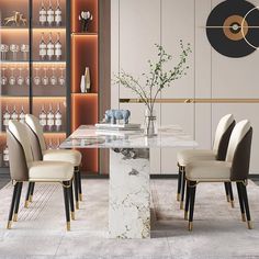 an elegant dining room with marble table and beige upholstered chairs in front of glass shelves filled with wine glasses