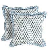 two blue and white pillows sitting next to each other