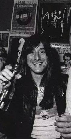 black and white photograph of two men holding up beer glasses in front of their faces