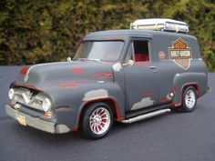 an old grey truck with flames painted on it