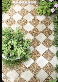 an aerial view of a garden with flowers and plants in the center, from above