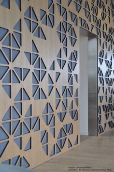 the wall is made out of wood and has geometric designs on it